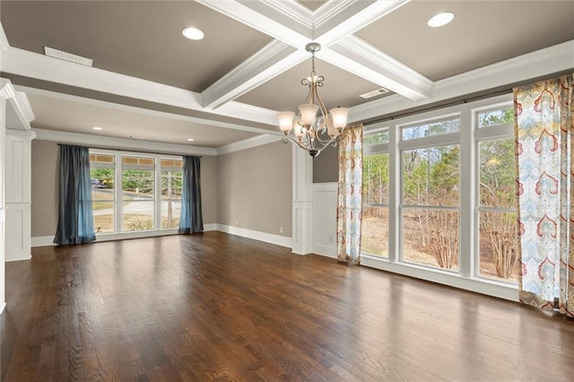 spare room featuring a chandelier, crown molding, healthy amount of natural light, beamed ceiling, and dark wood-type flooring