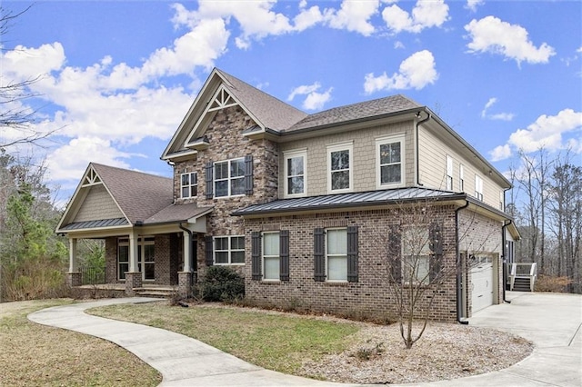 craftsman-style house featuring driveway, an attached garage, a porch, brick siding, and a front lawn