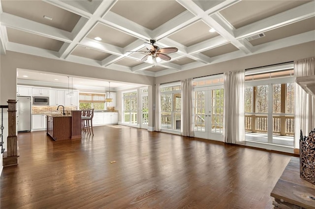 living area with dark wood-style flooring, a ceiling fan, beamed ceiling, recessed lighting, and coffered ceiling