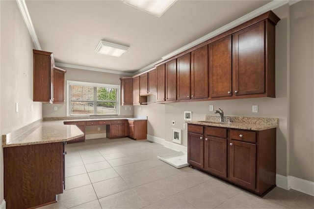 kitchen featuring a sink, light stone countertops, crown molding, light tile patterned floors, and baseboards