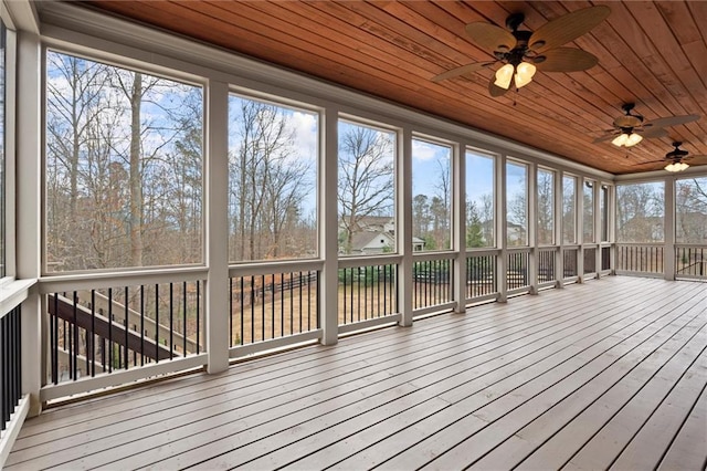 unfurnished sunroom with ceiling fan