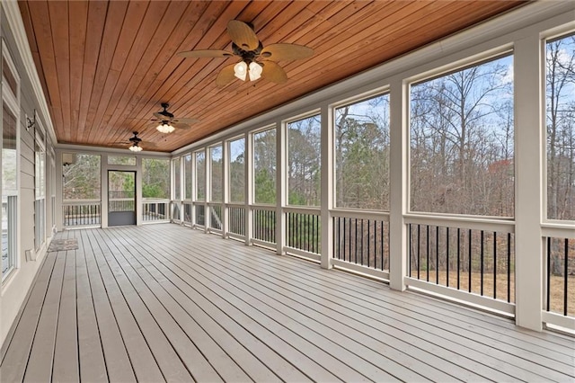 unfurnished sunroom featuring ceiling fan
