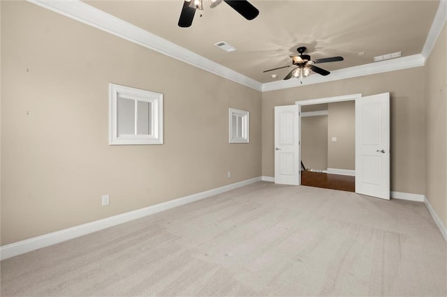 unfurnished bedroom featuring crown molding, baseboards, carpet flooring, and a ceiling fan