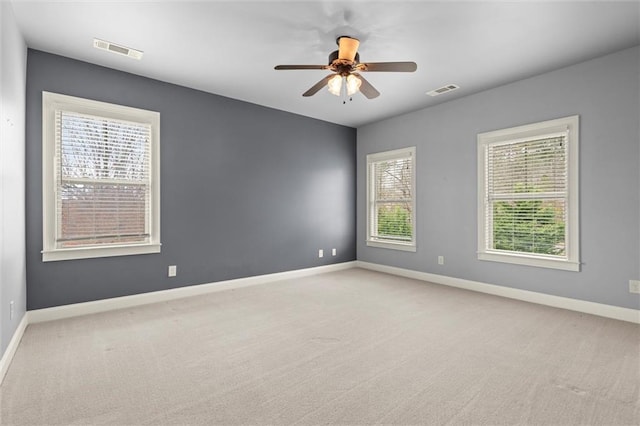 spare room with carpet, baseboards, and ceiling fan