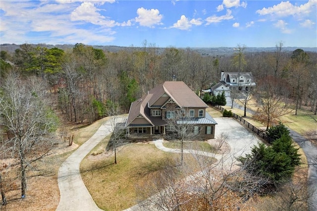 view from above of property featuring a heavily wooded area