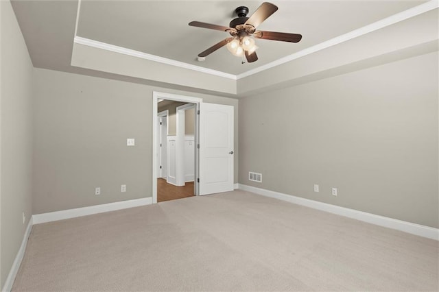 unfurnished bedroom with carpet flooring, ornamental molding, baseboards, and ceiling fan