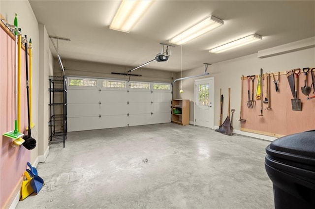 garage with a garage door opener and baseboards