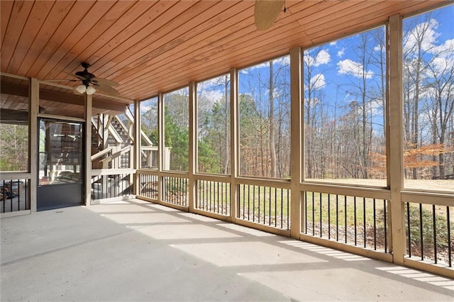 unfurnished sunroom with ceiling fan