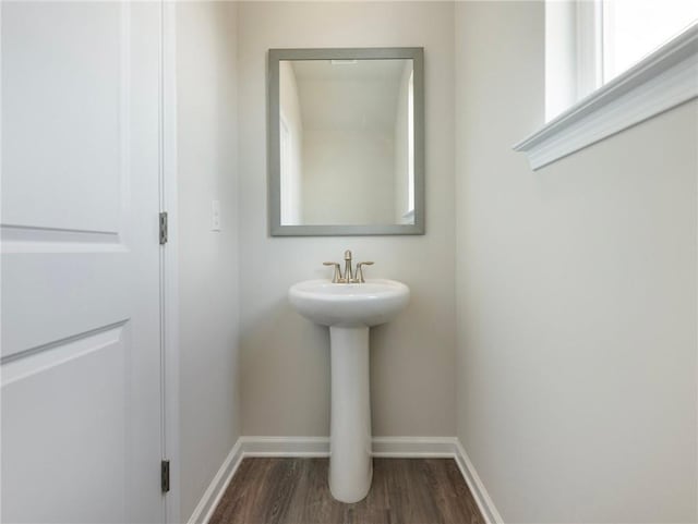 246 W Midland Ave, Winder, GA 30680 - bathroom featuring wood finished floors, baseboards, and a sink