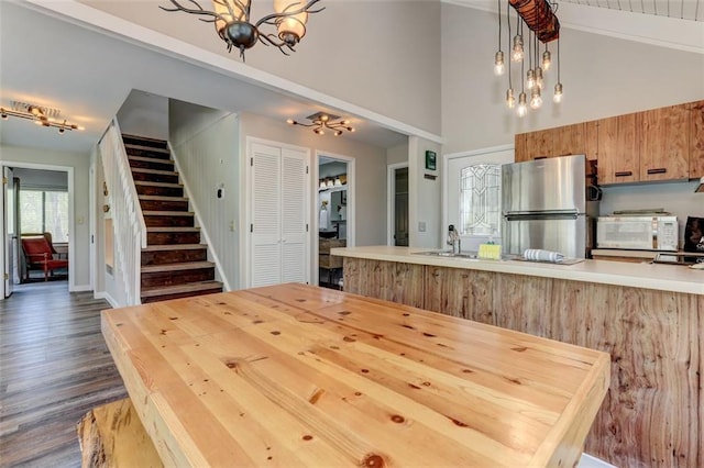 125 Wolfscratch Dr, Big Canoe, GA 30143 - dining area with a chandelier, stairway, high vaulted ceiling, and dark wood-style floors