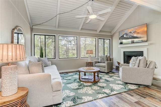 125 Wolfscratch Dr, Big Canoe, GA 30143 - living room featuring wood finished floors, plenty of natural light, a lit fireplace, a ceiling fan, and high vaulted ceiling