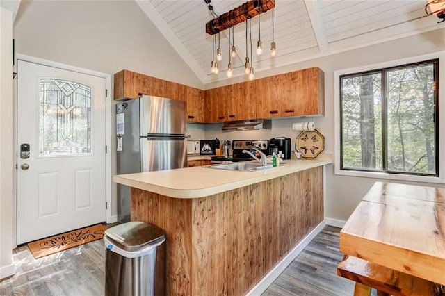 125 Wolfscratch Dr, Big Canoe, GA 30143 - kitchen with appliances with stainless steel finishes, a wood ceiling with exposed beams, brown cabinetry, a peninsula, and light countertops