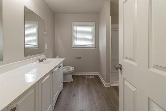 3821 Paul Samuel Rd NW, Kennesaw, GA 30152 - bathroom with visible vents, wood finished floors, toilet, and a healthy amount of sunlight