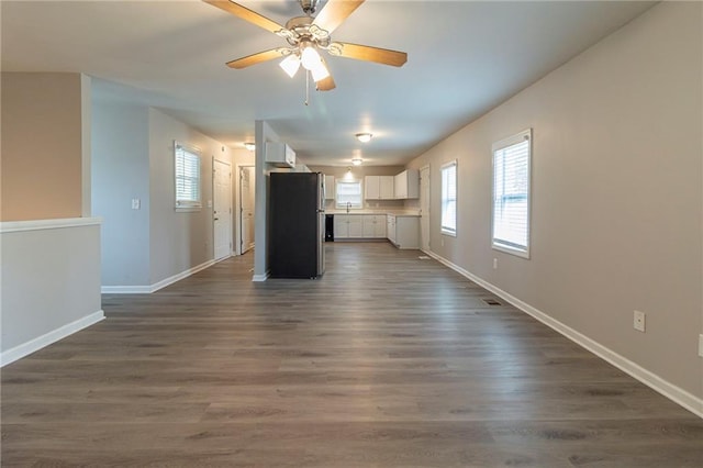 3821 Paul Samuel Rd NW, Kennesaw, GA 30152 - unfurnished living room with visible vents, baseboards, a sink, a ceiling fan, and dark wood-type flooring