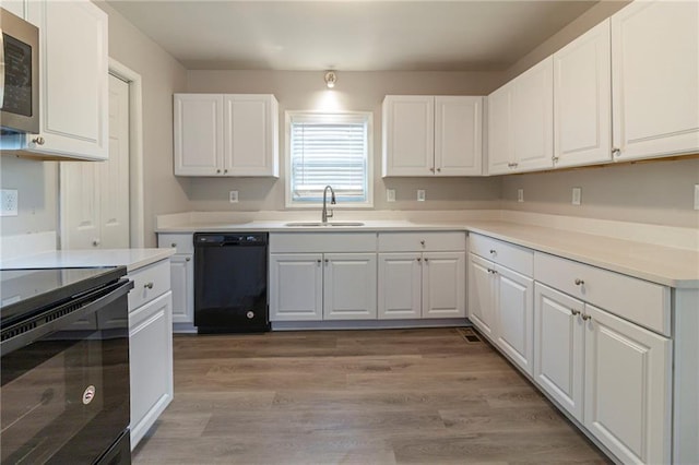 3821 Paul Samuel Rd NW, Kennesaw, GA 30152 - kitchen featuring white cabinets, a sink, and black appliances
