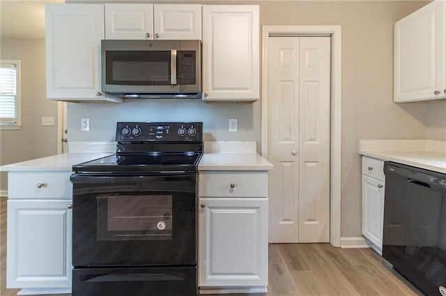 3821 Paul Samuel Rd NW, Kennesaw, GA 30152 - kitchen with light countertops, white cabinets, and black appliances