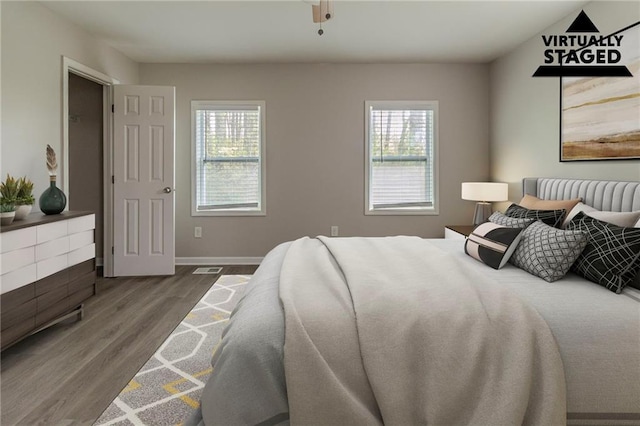 3821 Paul Samuel Rd NW, Kennesaw, GA 30152 - bedroom with multiple windows, baseboards, and wood finished floors