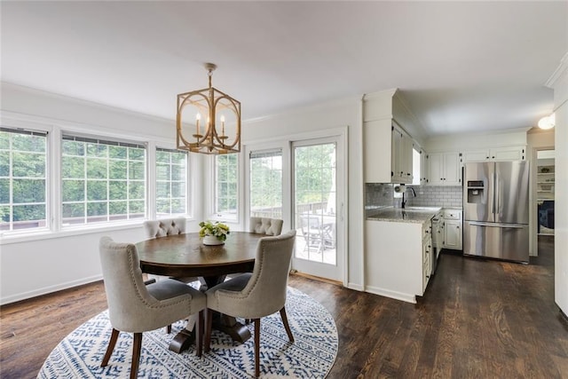 3707 Dunwoody Club Dr, Atlanta, GA 30350 - dining space featuring a chandelier, crown molding, dark wood-style flooring, and baseboards