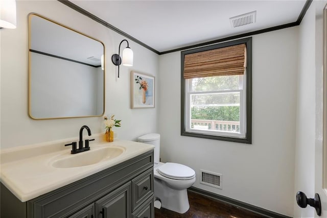 3707 Dunwoody Club Dr, Atlanta, GA 30350 - bathroom with toilet, ornamental molding, vanity, and wood finished floors