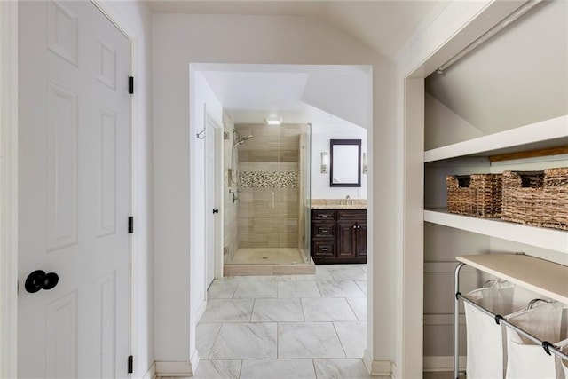 3707 Dunwoody Club Dr, Atlanta, GA 30350 - bathroom featuring marble look tile flooring, a shower stall, vanity, and lofted ceiling