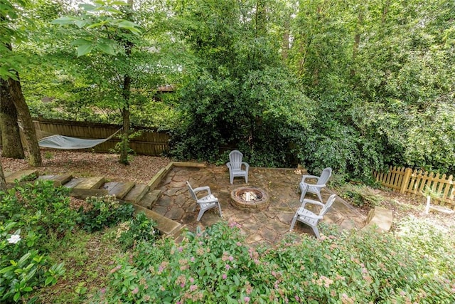 3707 Dunwoody Club Dr, Atlanta, GA 30350 - fenced backyard featuring an outdoor fire pit and a patio area