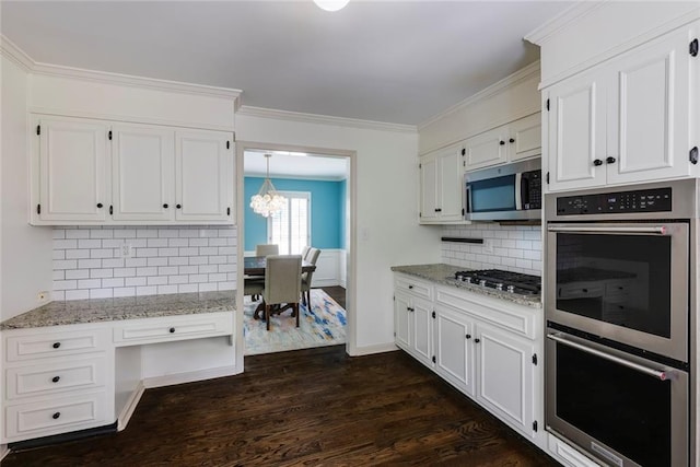 3707 Dunwoody Club Dr, Atlanta, GA 30350 - kitchen featuring appliances with stainless steel finishes, dark wood finished floors, a chandelier, white cabinetry, and light stone countertops