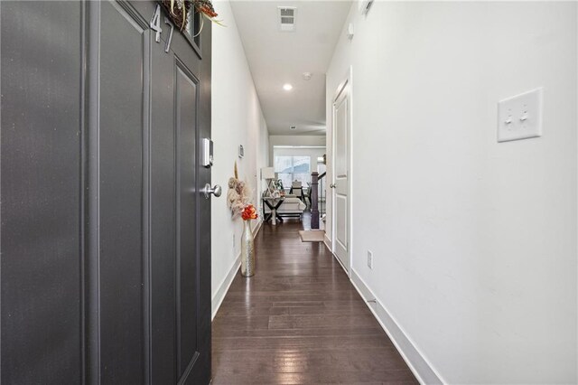 hallway with dark hardwood / wood-style floors