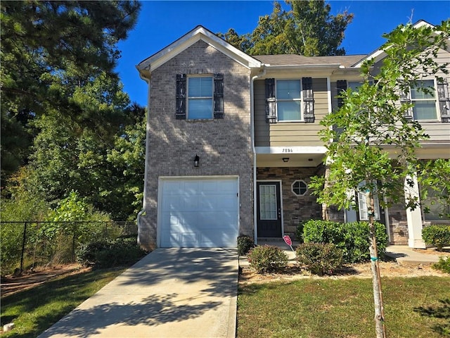 view of front of house featuring a front yard and a garage