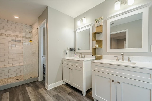 875 Soaring Cir, Marietta, GA 30062 - bathroom featuring a shower stall, two vanities, wood finished floors, and recessed lighting