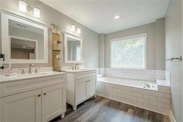 875 Soaring Cir, Marietta, GA 30062 - full bathroom featuring two vanities, a bath, and wood finished floors