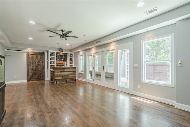 875 Soaring Cir, Marietta, GA 30062 - unfurnished living room with a barn door, wood finished floors, recessed lighting, a ceiling fan, and french doors