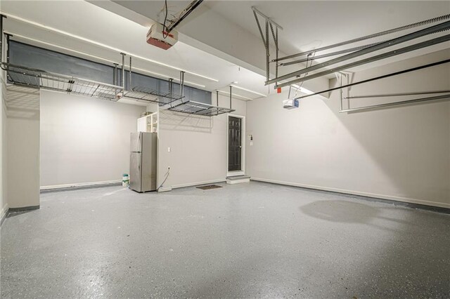 875 Soaring Cir, Marietta, GA 30062 - garage featuring freestanding refrigerator and a garage door opener