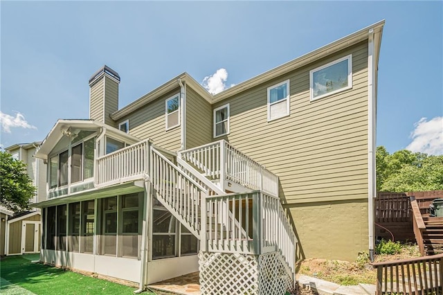 875 Soaring Cir, Marietta, GA 30062 - back of property featuring stairway, a sunroom, a wooden deck, a storage unit, and a chimney