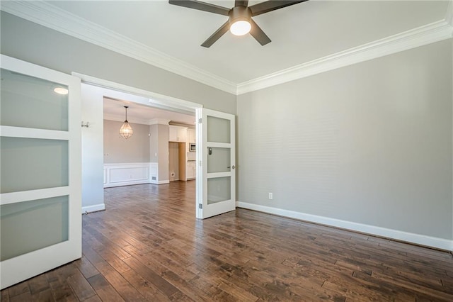 875 Soaring Cir, Marietta, GA 30062 - spare room with crown molding, dark wood finished floors, a ceiling fan, french doors, and wainscoting