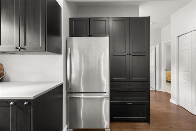 kitchen with stainless steel fridge and dark hardwood / wood-style flooring