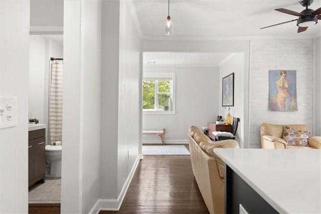 interior space with hardwood / wood-style flooring, ceiling fan, crown molding, and vanity