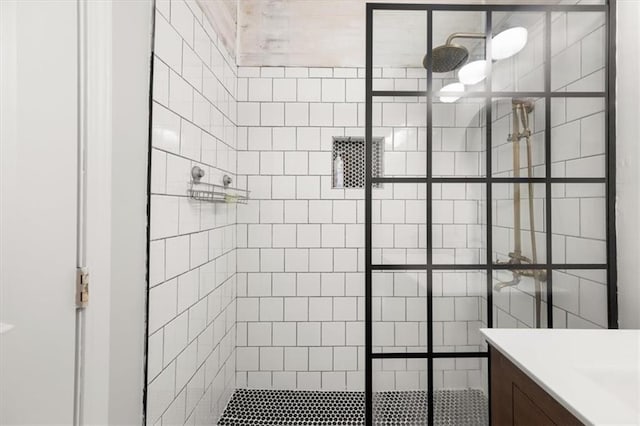 bathroom featuring vanity and tiled shower