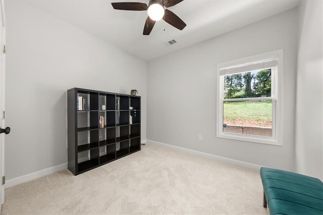 sitting room with light colored carpet and ceiling fan