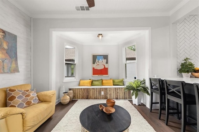 living area with dark hardwood / wood-style flooring and crown molding