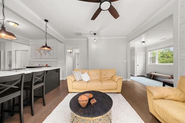 living room with ceiling fan, dark hardwood / wood-style flooring, and ornamental molding