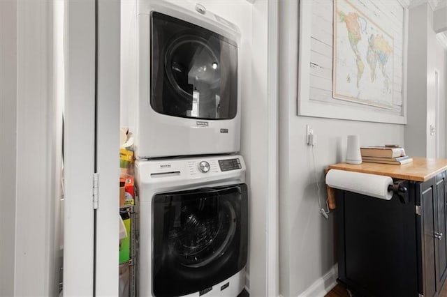 laundry area featuring stacked washer and dryer