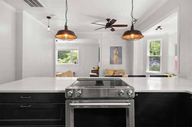 kitchen with pendant lighting, stainless steel range with electric cooktop, and a wealth of natural light