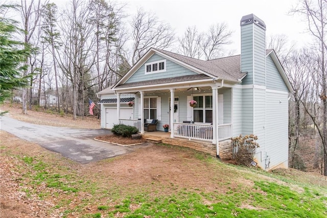 view of front of home featuring covered porch and a garage