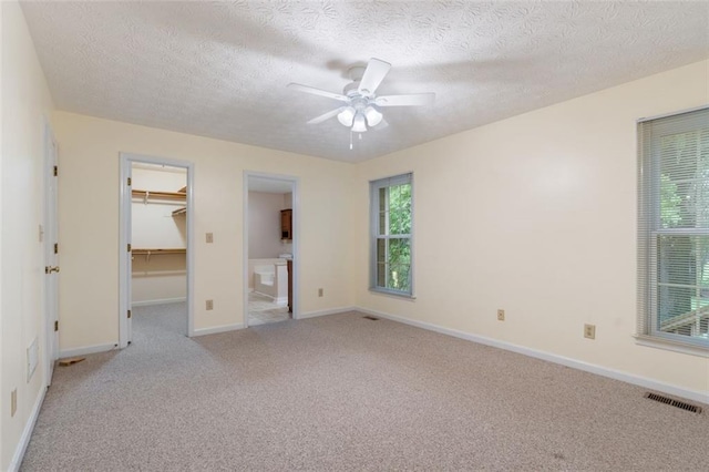 48 Saddle Field Cir NW, Cartersville, GA 30121 - unfurnished room featuring light carpet, a ceiling fan, a textured ceiling, and baseboards