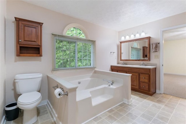 48 Saddle Field Cir NW, Cartersville, GA 30121 - bathroom featuring double vanity, a bath, a textured ceiling, toilet, and tile patterned flooring