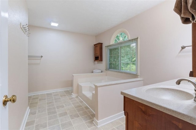48 Saddle Field Cir NW, Cartersville, GA 30121 - full bath with a garden tub, double vanity, tile patterned flooring, and baseboards