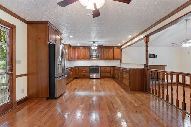 48 Saddle Field Cir NW, Cartersville, GA 30121 - kitchen with stainless steel appliances, ceiling fan, brown cabinetry, light wood-style flooring, and a textured ceiling