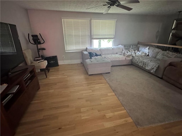 living area featuring ceiling fan and light wood-style flooring