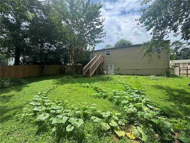 view of yard featuring stairway and a wooden deck