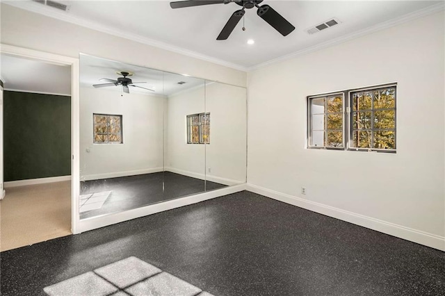 spare room with baseboards, visible vents, and crown molding